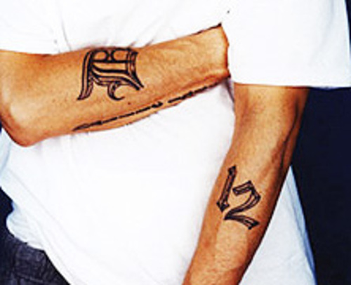 Eminem D Font Tattoo on Right Arm