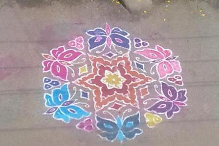 Rangoli Design Surrounded By Butterflies
