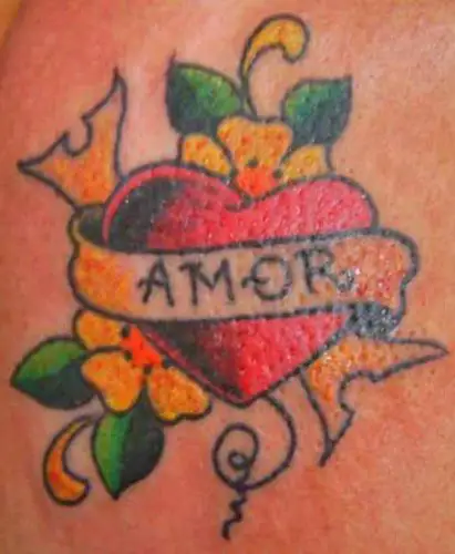 Amor lettering tattoo on the inner forearm