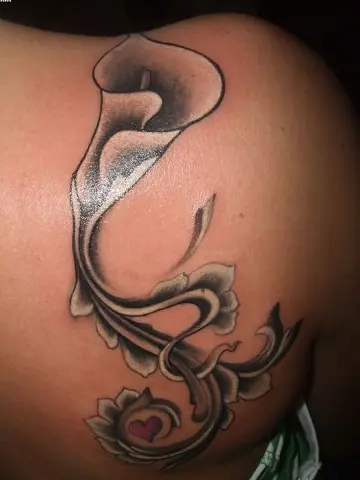 Fine line calla lily tattoo located on the tricep