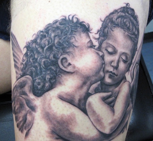 Father with tattoos holding baby son stock photo