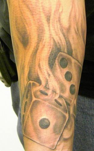 The Skull And Dice Fire Tattoos on Forearm