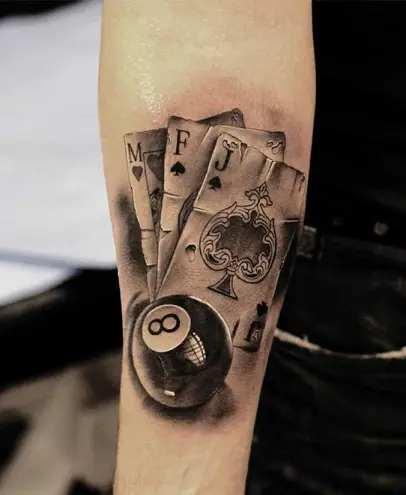 Minimalist eightball tattoo on the upper arm