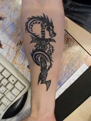 Premium Vector  Tribal sword with wings logo tattoo design stencil vector  illustration