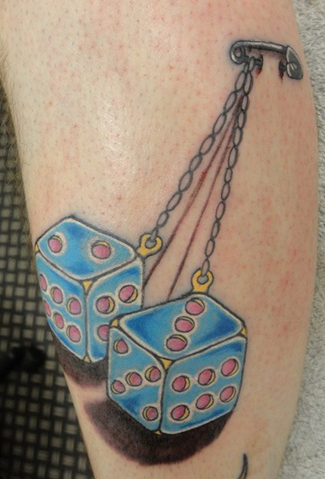 Tied up dice tattoo