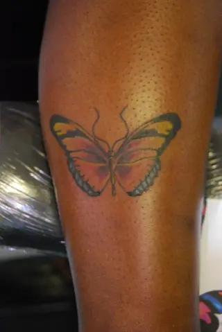 Butterfly colour tattoo on Dark skin  Blue butterfly tattoo Colorful butterfly  tattoo Purple tattoos