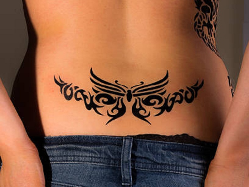 A high resolution image of a Girl with a lower back tribal tattoo