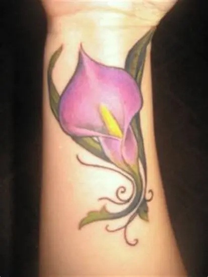 Fine line calla lily tattoo located on the tricep
