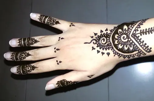Premium Photo  Henna tattoo on woman hands artist drawing arabic mehndi