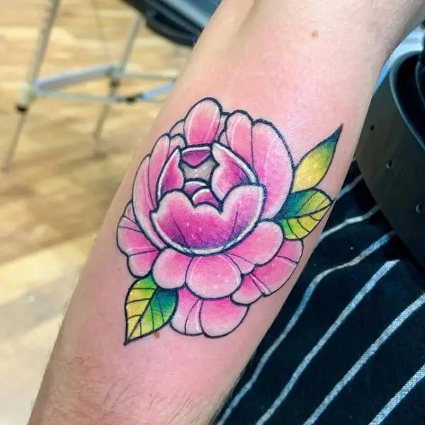 Pink peony tattoo on the inner forearm