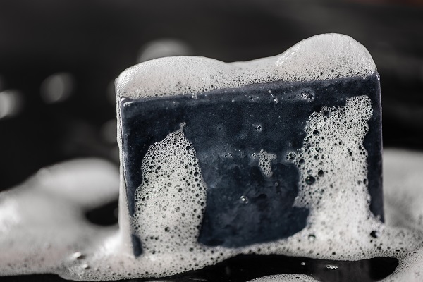 Black,charcoal,carbon,soap,on,black,background,with,soap,bublles