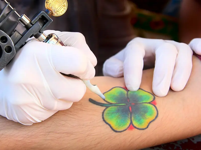 Small green clover tattoo on the right hand