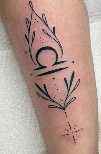 Fresh crescent moon and Libra symbol tattoos on