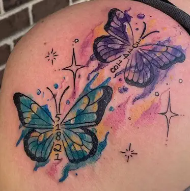 Fine line butterfly tattoo located on the upper back