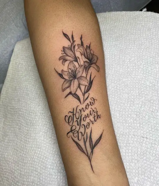 Purple lily flower tattoo on the wrist