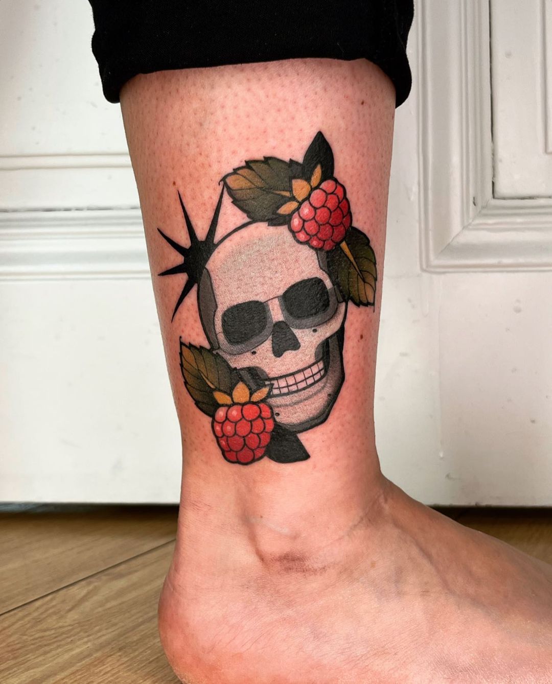 Berry Adorned Tattoo Of A Skull