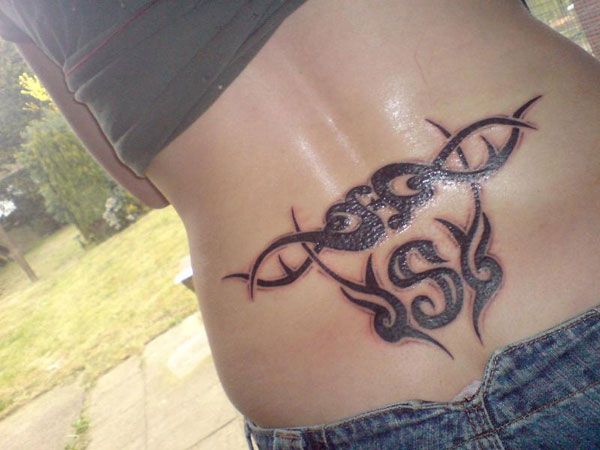 Eye Catching Lower Back S Letter Tattoo