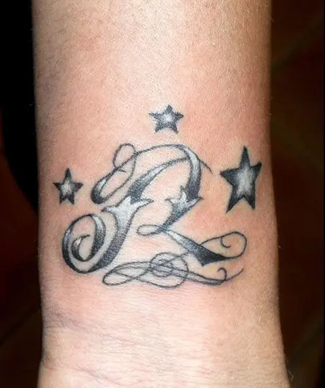 Letter R With Crown Tattoo On Left Shoulder