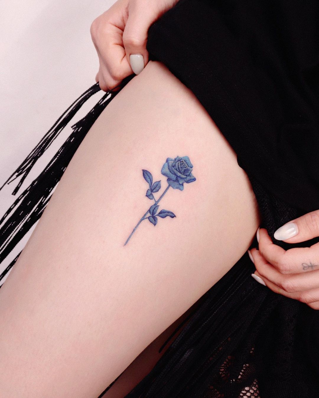 A Touch Of Blue On The Thigh Tattoo