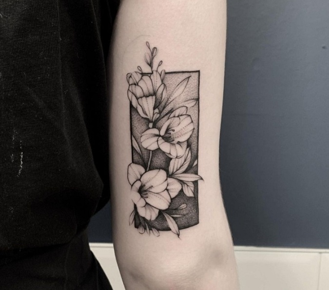 Awesome Freesia Flower Tattoo On The Elbow