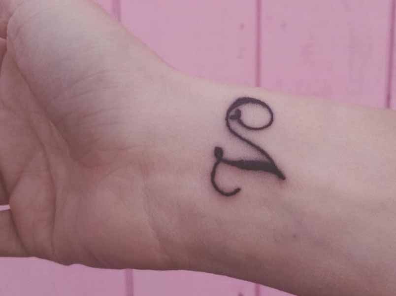 Striking V Letter Design Tattoo On The Wrist