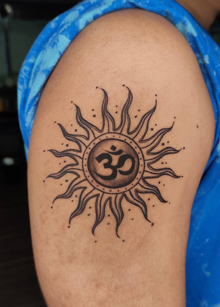Tribal Sun Tattoo Design On The Bicep
