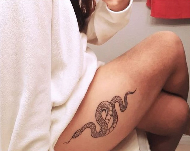 Real Python wraps around owners legs The tattoo on the back of the owners  thighs says GAME OVER Owner rescues snakes and is heavily into gaming  Stock Photo  Alamy