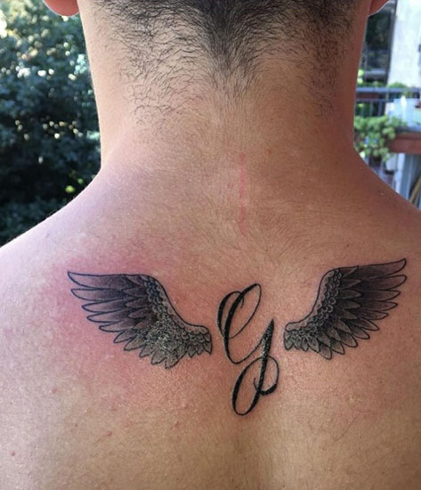 Cursive G Tattoo With Wings On The Back