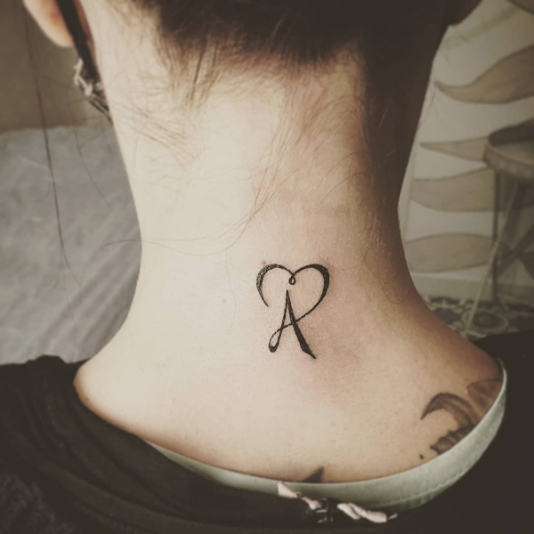A Letter Tattoo On The Neck
