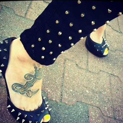 Extensive L Letter Tattoo On The Feet