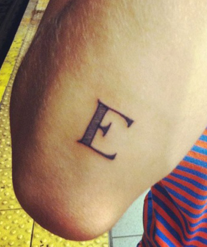 Striking E Letter Design Near The Elbow