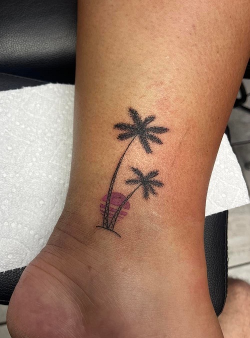 Fine line palm tree tattoo on the ankle.