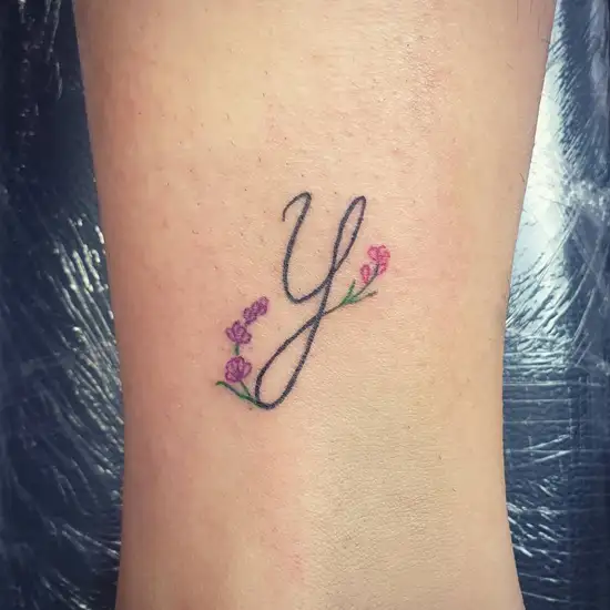 Buttercup and Y letter tattoo on the ankle