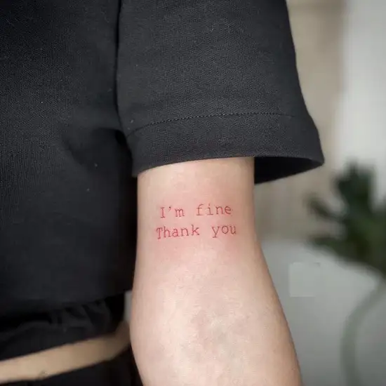 Red ink H letter tattoo om the rib