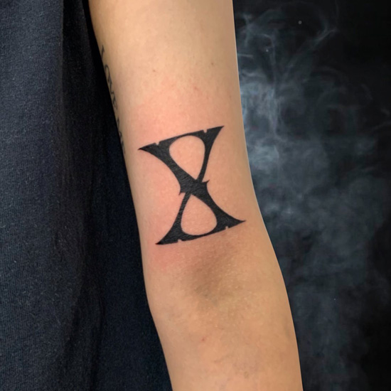 X Letter Tattoo In The Shape Of Hourglass