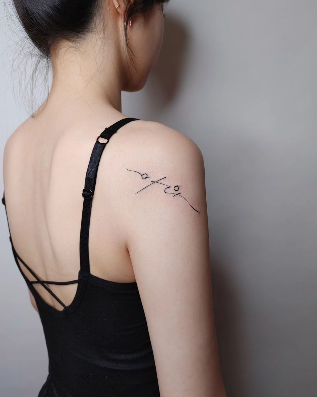 Minimalist Shoulder Name Tattoo In Elegant Script
