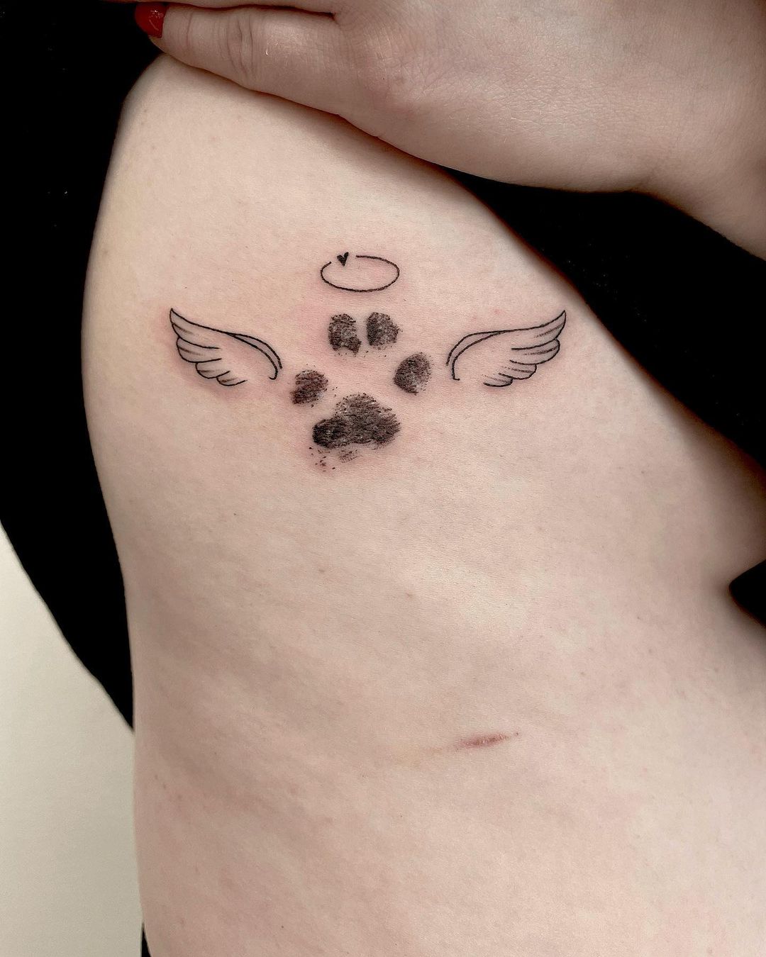 Heartfelt Paw Print Tattoo With Wings On Side Rib