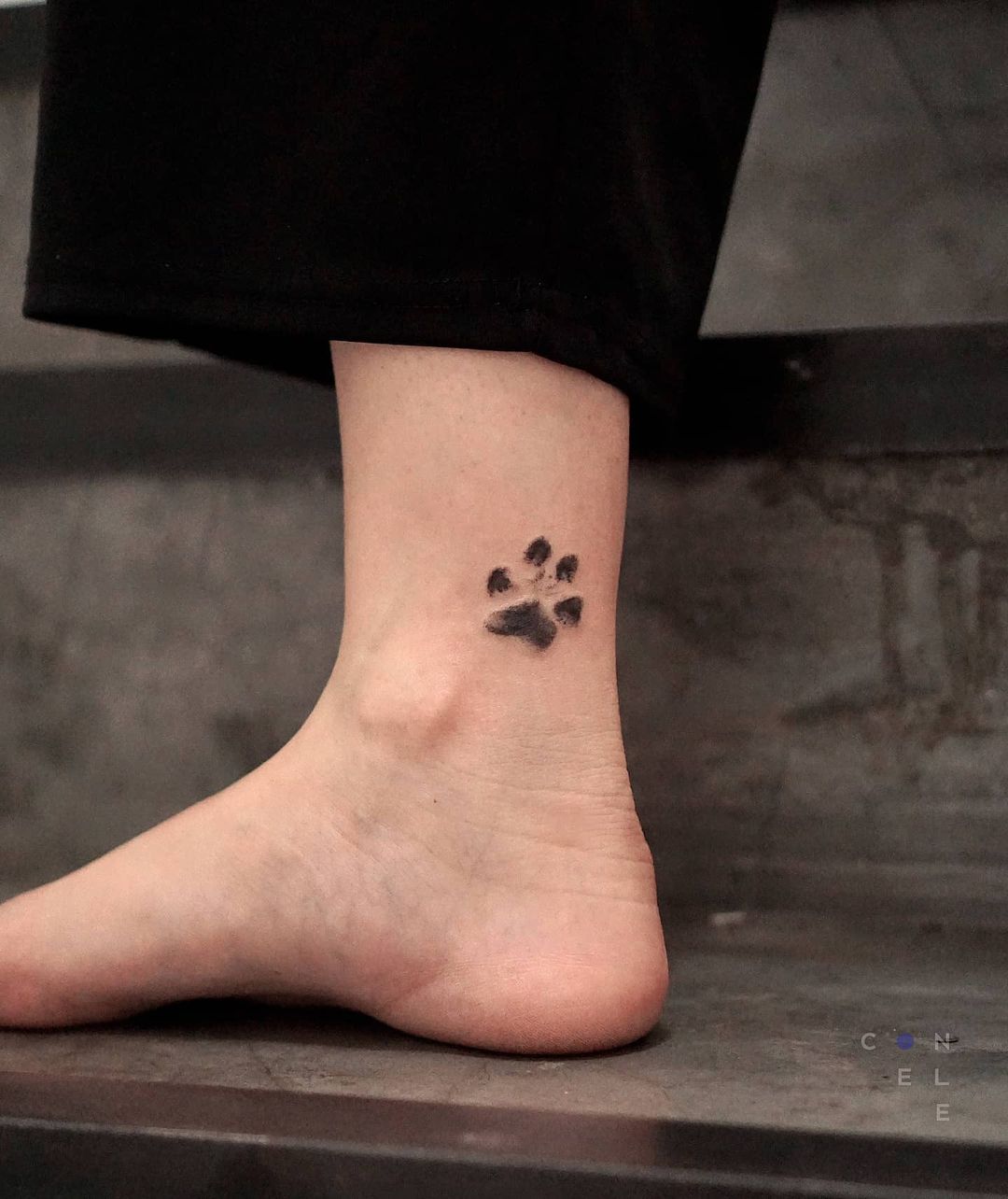 Small Paw Print Tattoo On The Ankle