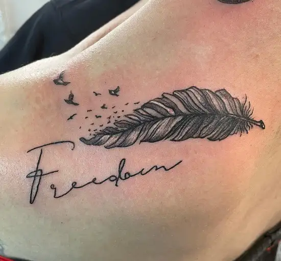 Inner arm tattoo saying Freedom in arabic حرية