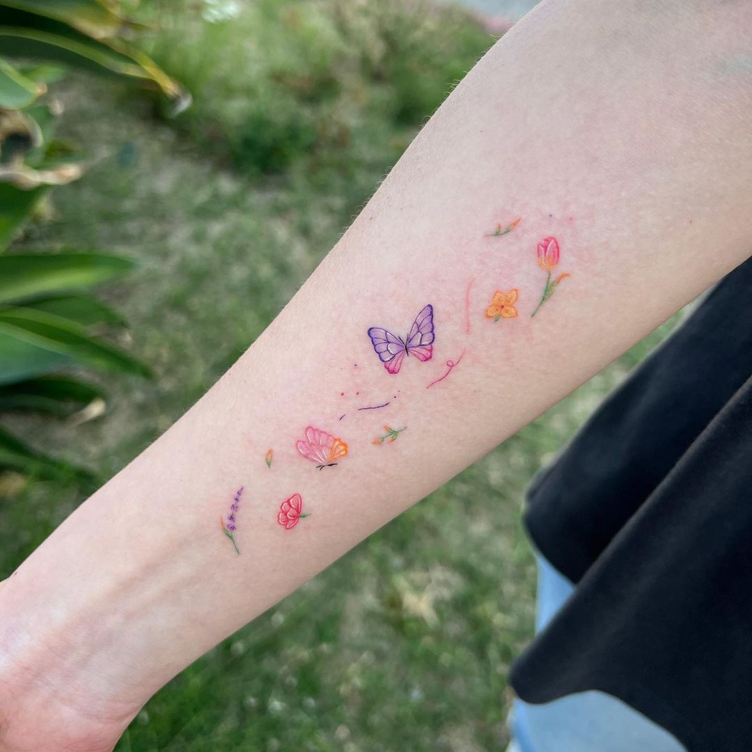 Colorful Butterfly And Flower Arm Tattoo
