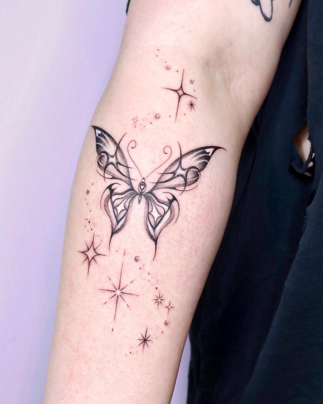 Gothic Butterfly Tattoo On Forearm With Stars