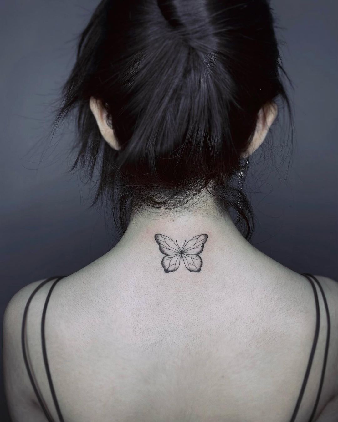 Minimalist Butterfly Tattoo On The Nape Of The Neck