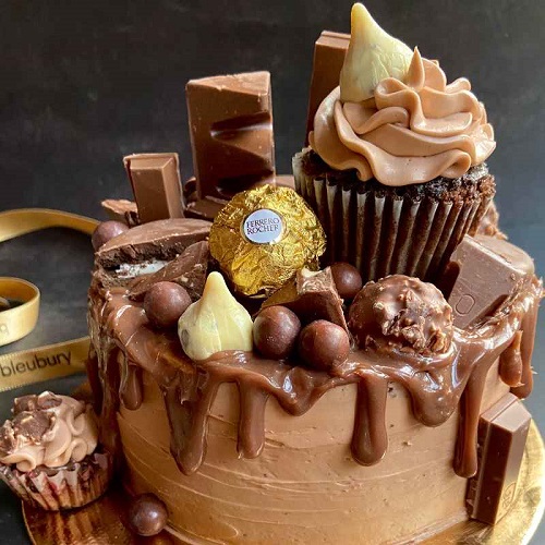 Chocolate layered tall drip glitter cake, gold and silver Maltesers stars  and rolos | Candy birthday cakes, Chocolate cake designs, Pumpkin cake