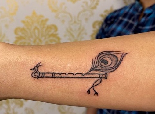 Om  Flute on Peacock Feather Tattoo  Ace Tattoo