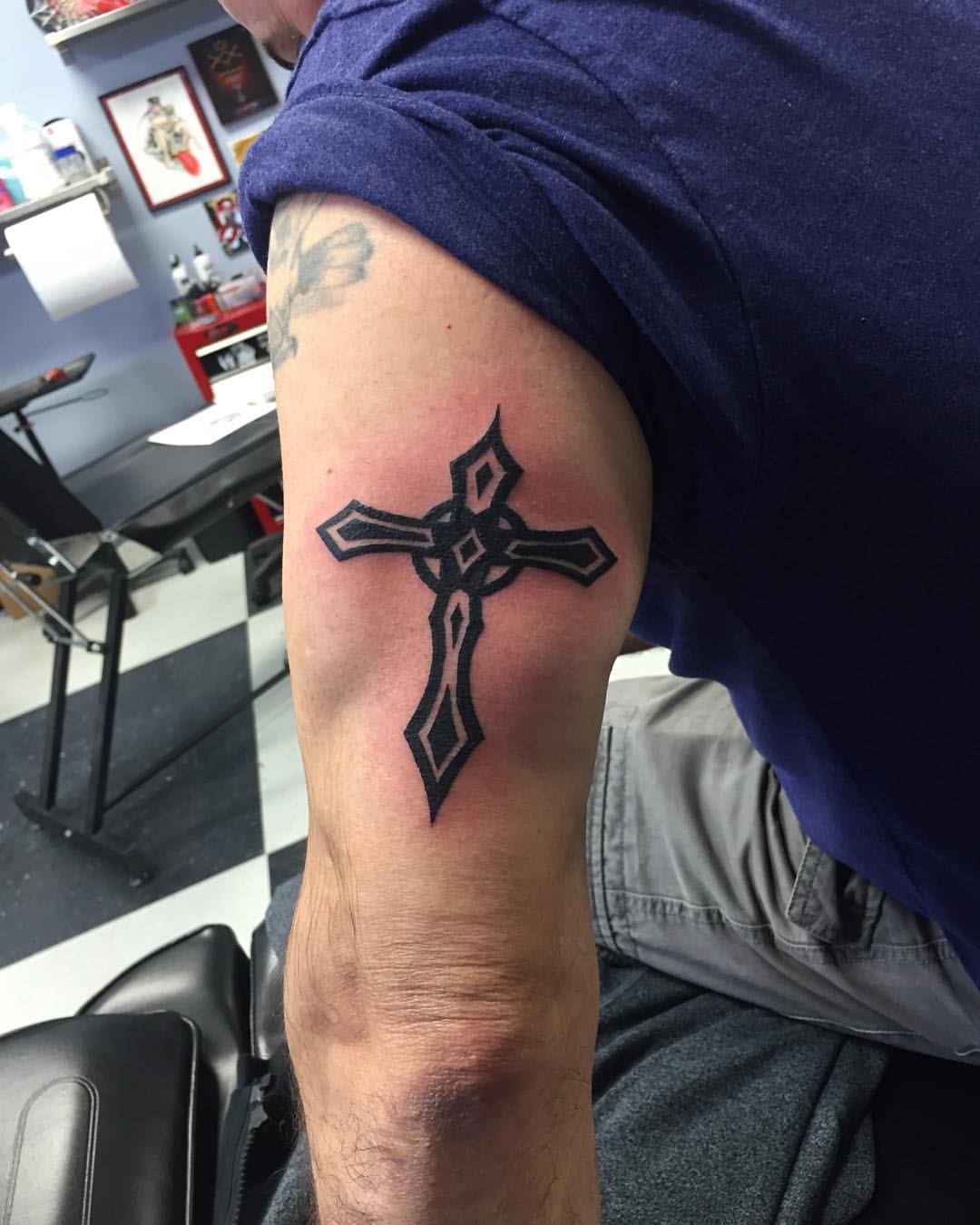 Bold Tribal Cross Design On Upper Arm Tattoo
