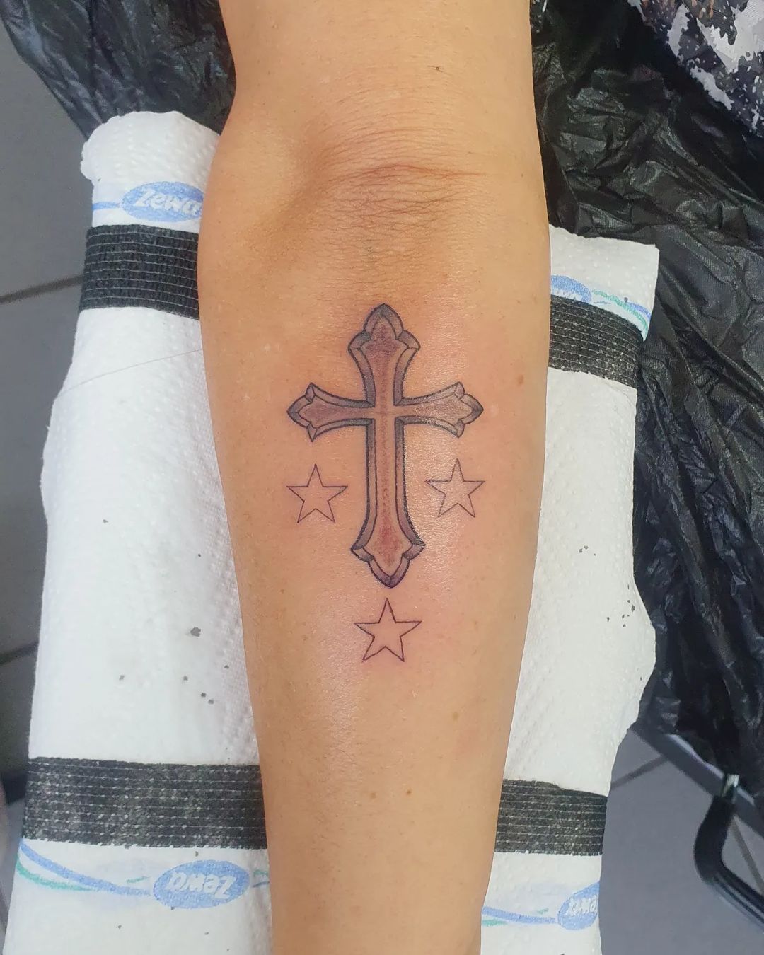 Cross Forearm Tattoo Accented With Stars