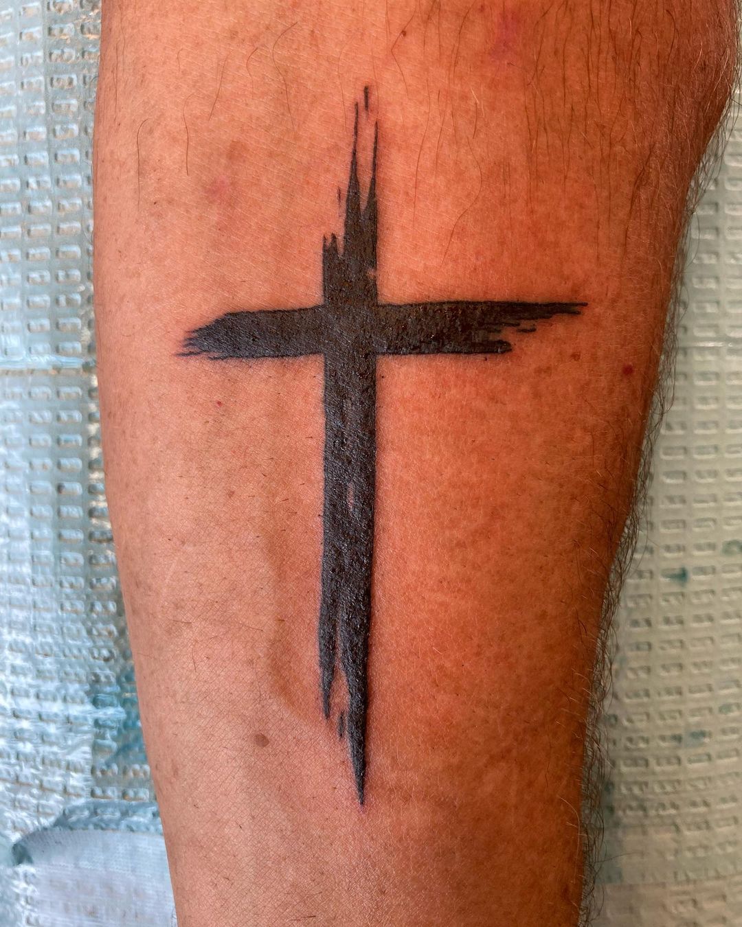 Simple Tribal Cross Tattoo On Leg Suitable For All Genders