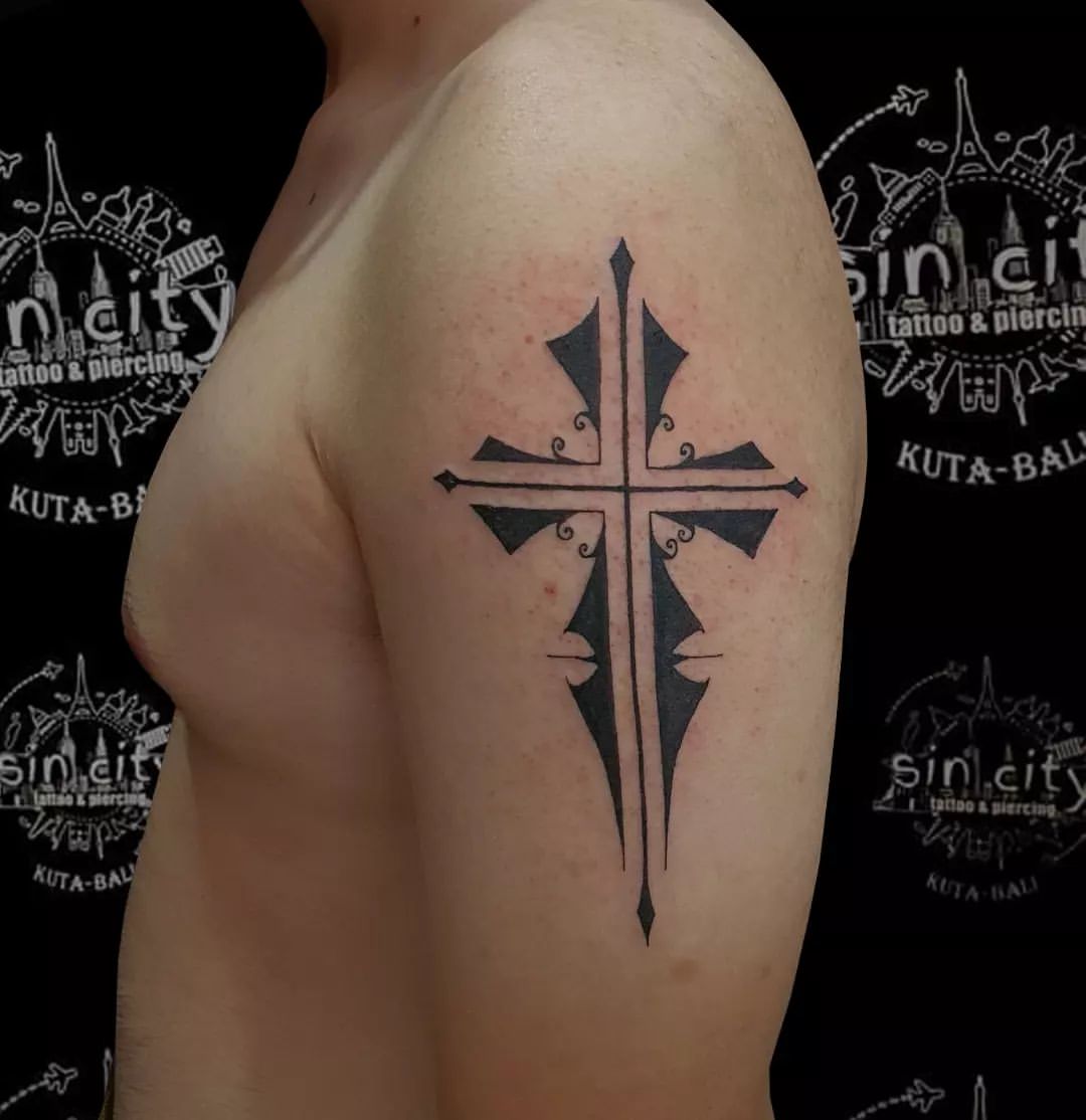 Sleek Tribal Cross Arm Tattoo