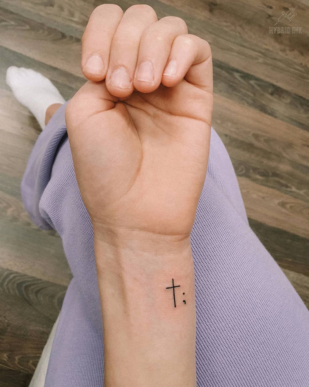 Sleek Wrist Cross Tattoo
