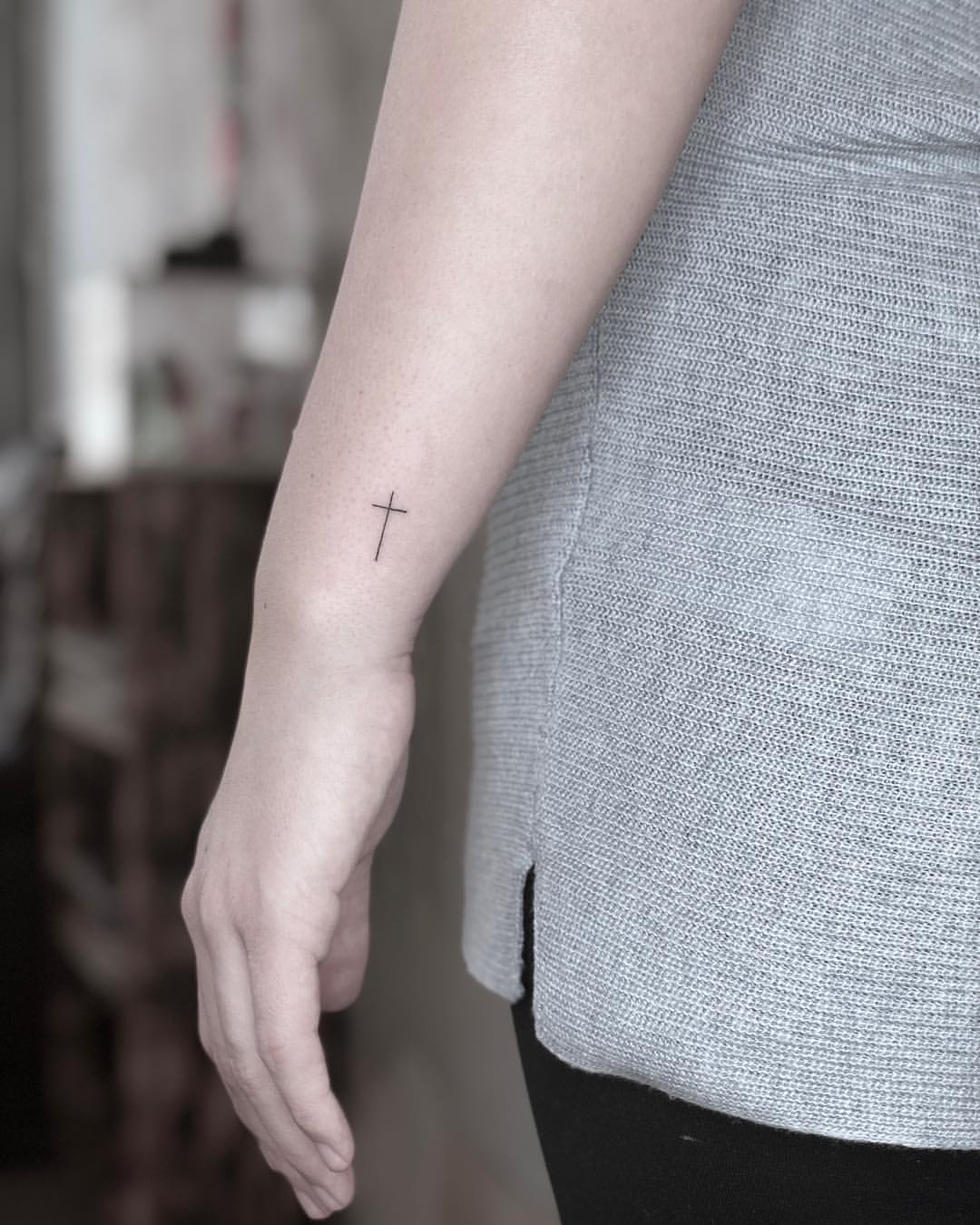 Subtly Simple Cross Small Tattoo On The Arm